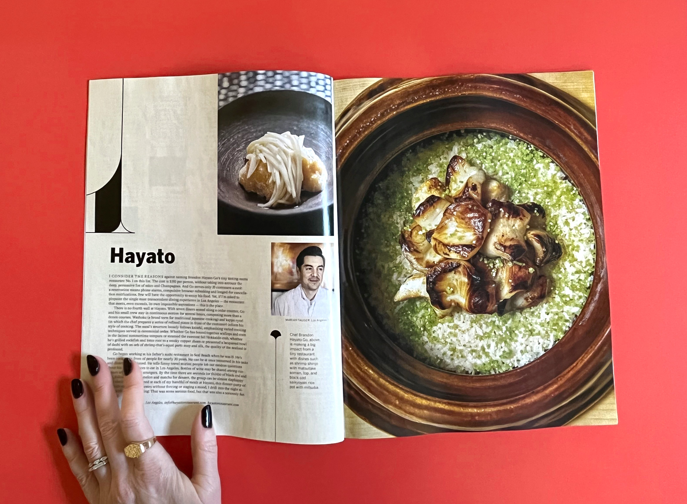 101 best restaurants list magazine open to number 1 spread with hand